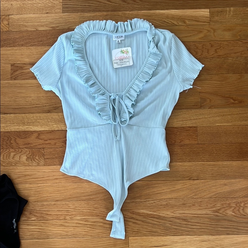 ISSI Blue Ruffled Tie Front Bodysuit